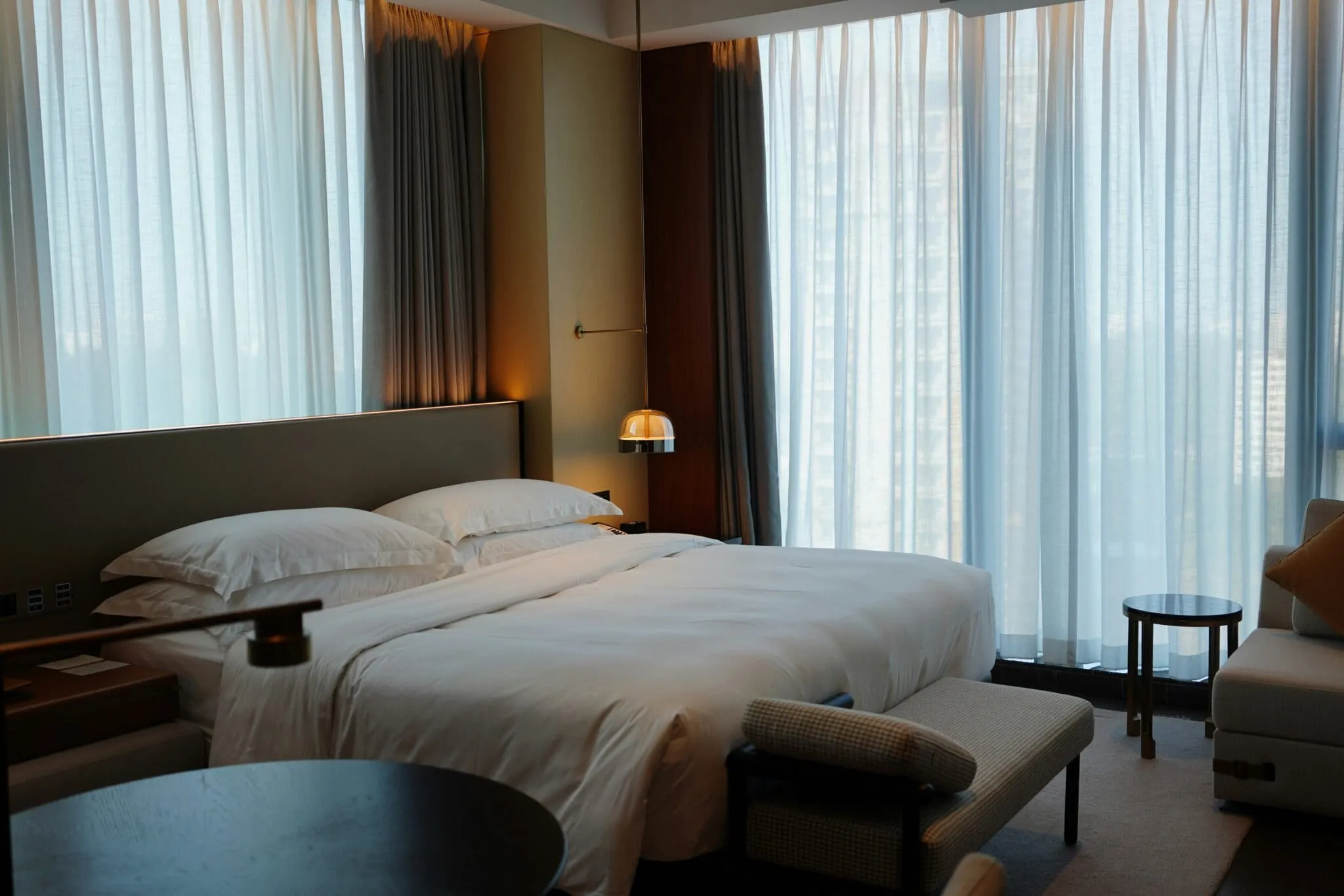 Interior view of a modern luxury hotel room with a King-size bed.